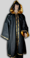 Robe made from black cotton twill fully lined in gold satin with trim 202 around opening, hem and sleeves. Made in USA.