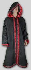 Robe with hood  made from black twill cotton lined in red satin with trim 214 on sleeves, around opening and hem. Custom-made in USA.